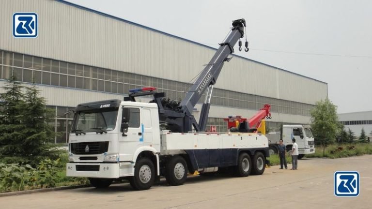 The HOWO 8X4 Wrecker Truck in operation at a rescue scene, with its WD615.69 engine and heavy-duty capability, extended boom and multiple axles to ensure stability