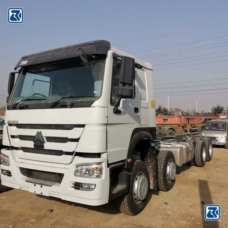 Side view of white HOWO 6x6 cargo truck showcasing the tire profile and the driver's cabin with air conditioning unit on top.